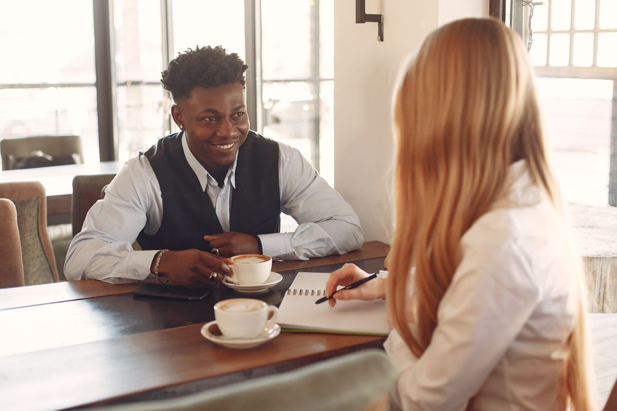 Two professionals having a relaxed one-on-one conversation over coffee